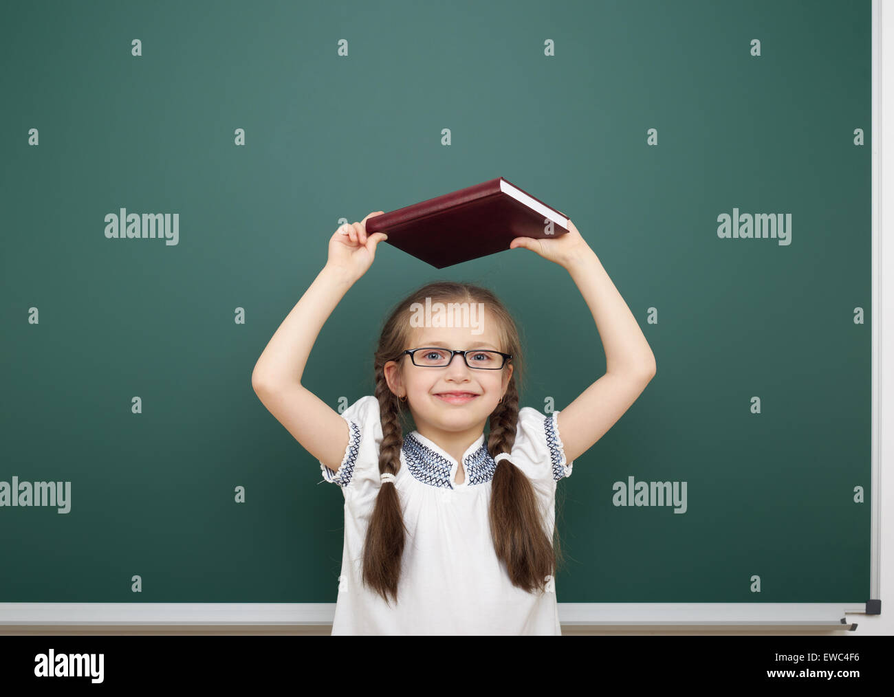 Schoolgirl near school board Stock Photo - Alamy