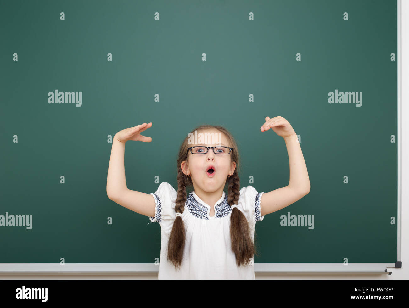 Schoolgirl near school board Stock Photo - Alamy