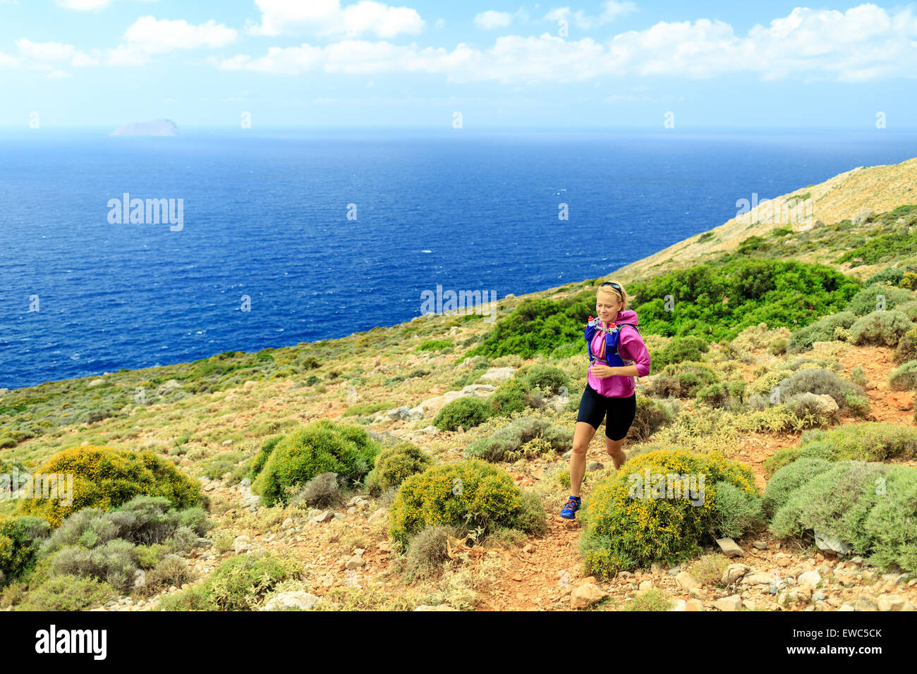 Trail running woman cross country running in mountains, healthy