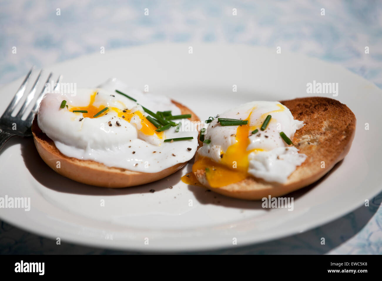 Two poached eggs on a toasted bagel Stock Photo