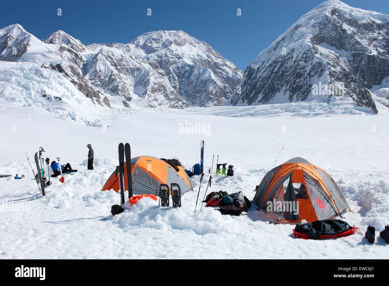 A team of mountaineers is resting in their camp with tents on the lower Kahiltna glacier on their way to Mount McKinley in Stock Photo