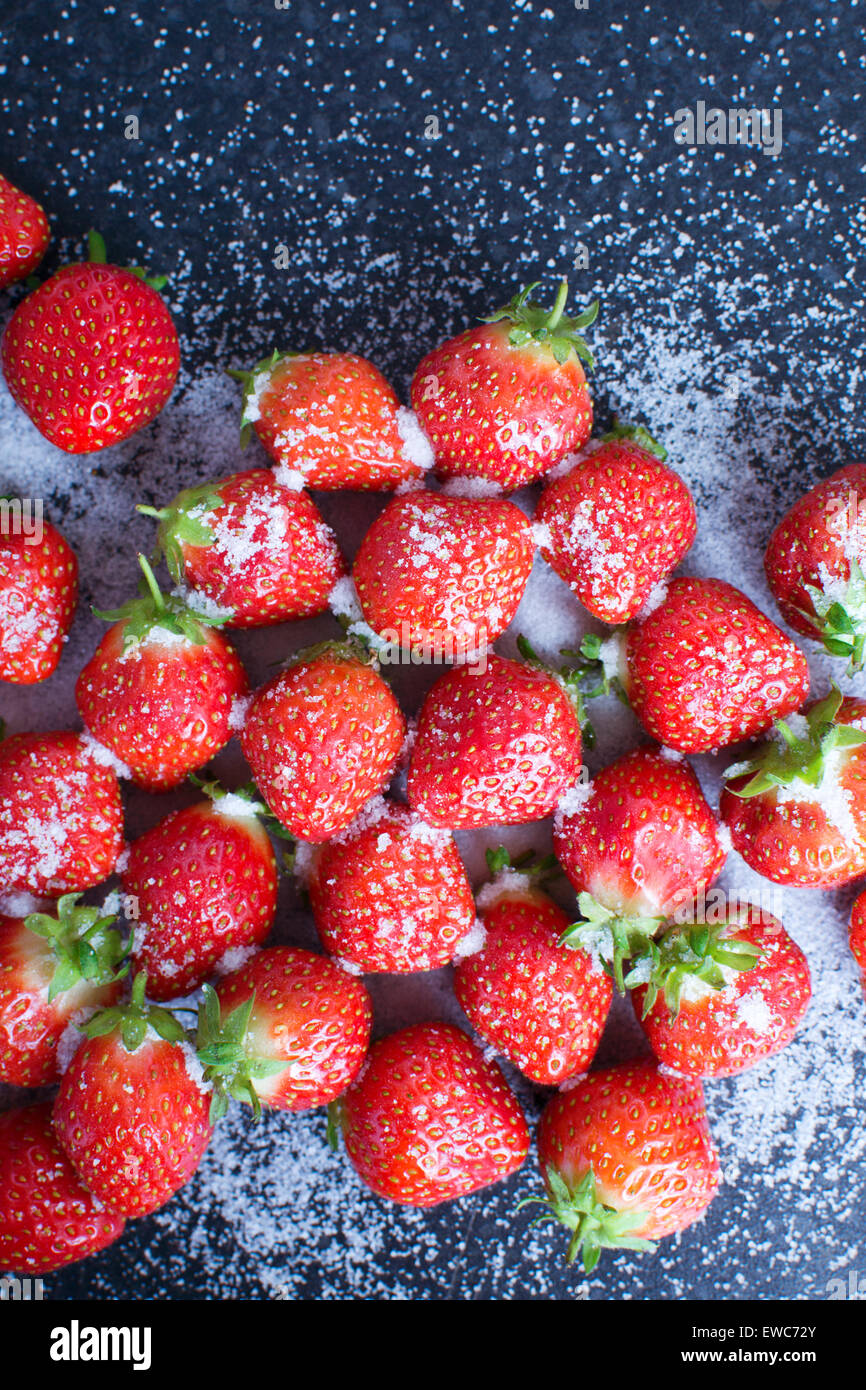 Fresh strawberries and sugar on a kitchen worktop Stock Photo - Alamy