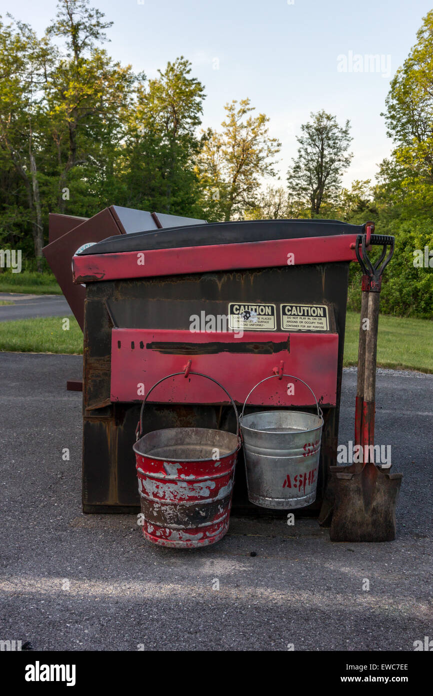 A dumpster with buckets with disposing of campfire ashes Stock Photo