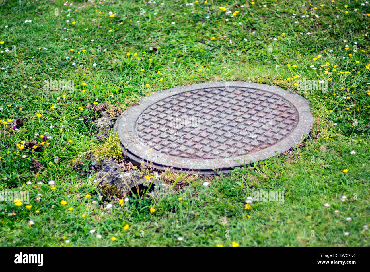 manhole cover in the middle of the mountains Stock Photo