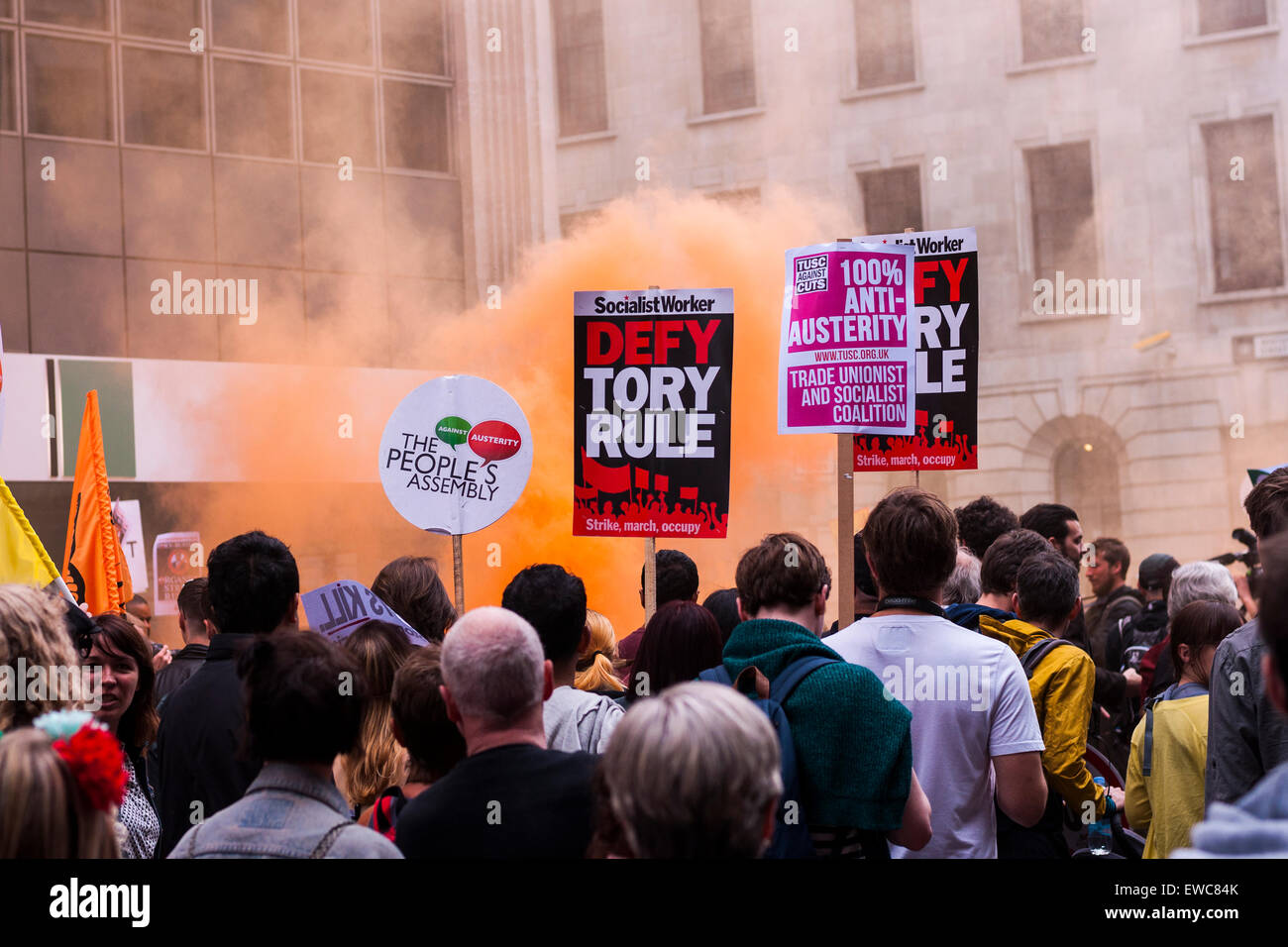Orange smoke on march against austerity in London on June 20 2015 Stock Photo
