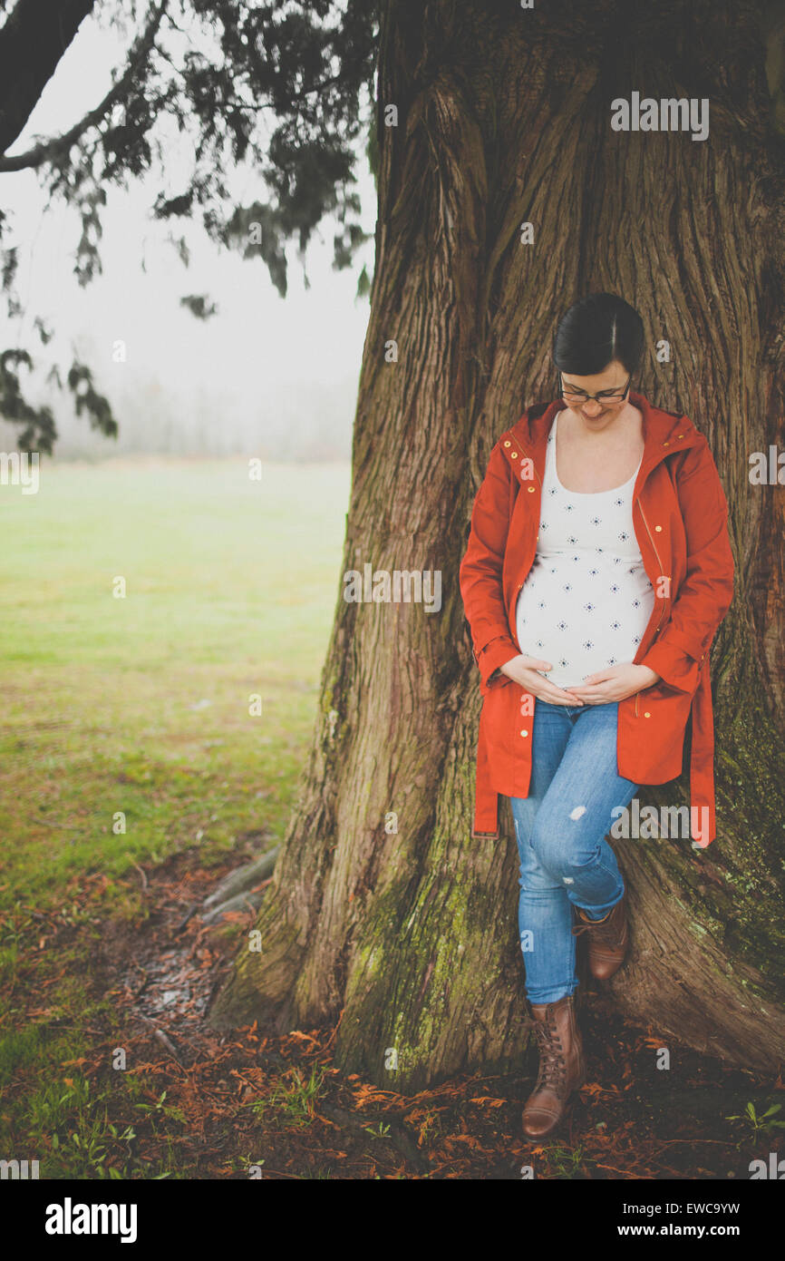 Portrait of a pregnant woman holding her belly Stock Photo - Alamy