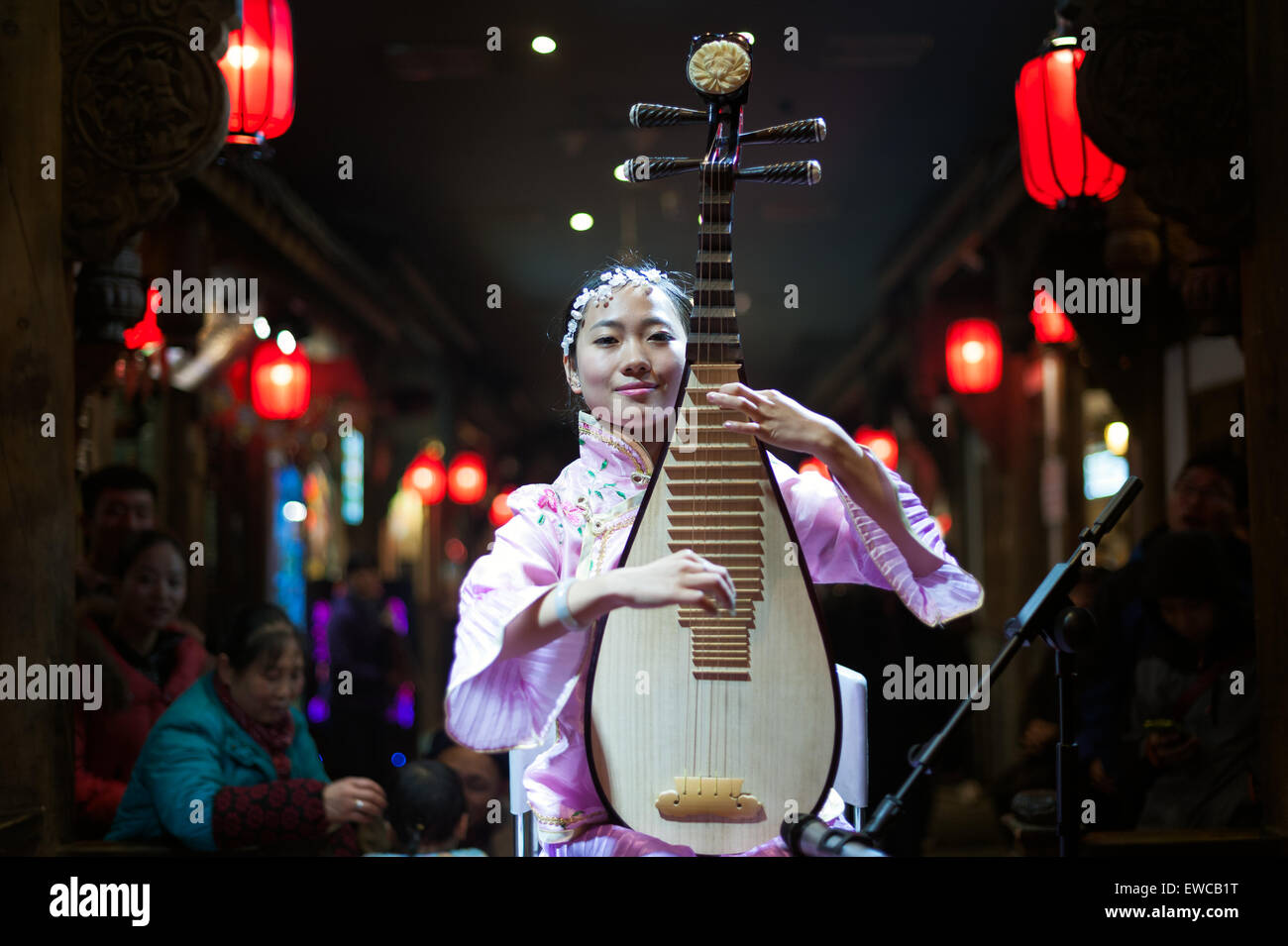 Chengdu - December 29 2014: Chinese musician girl playing traditional chinese guitar or piba onstage at Chunxifang Chunxilu on D Stock Photo