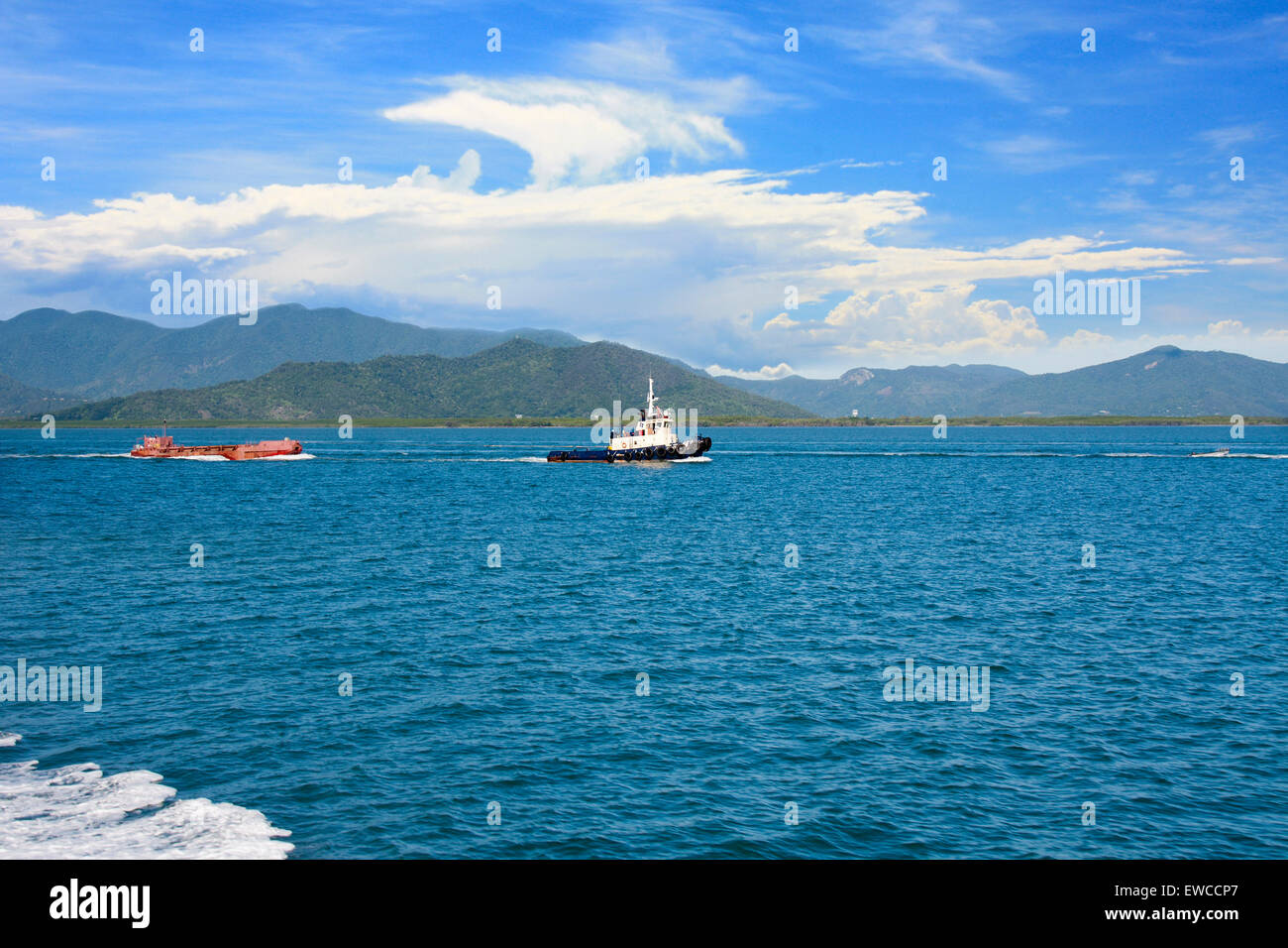 tug boat towing a vessel in the Cairns harbor Australia Stock Photo