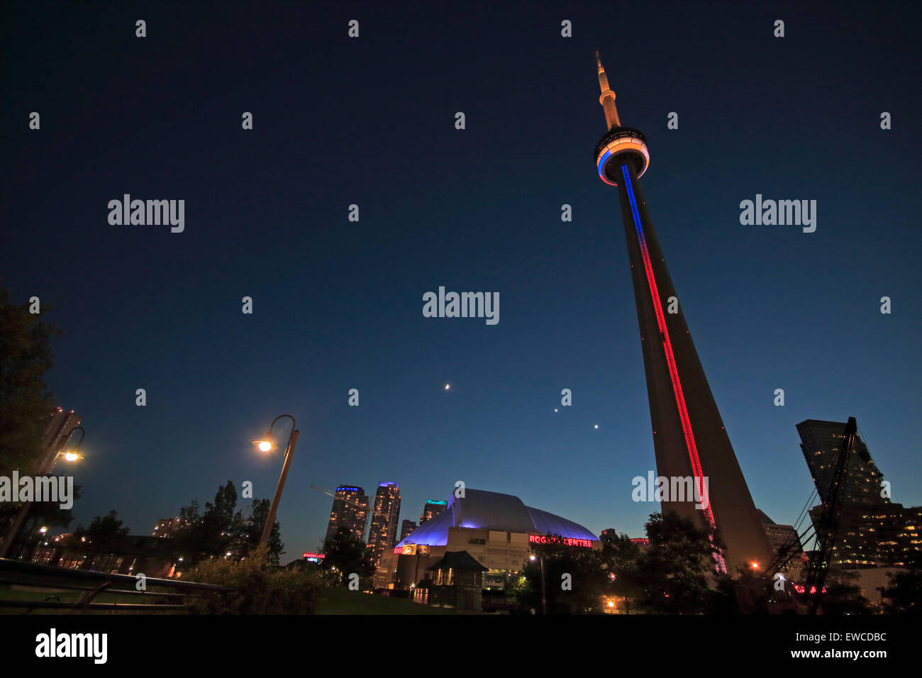 Toronto CN Tower and Rogers Centre at night. Crescent Waxing Moon, Venus and Jupiter forming a conjunction in the sky. Venus and Stock Photo