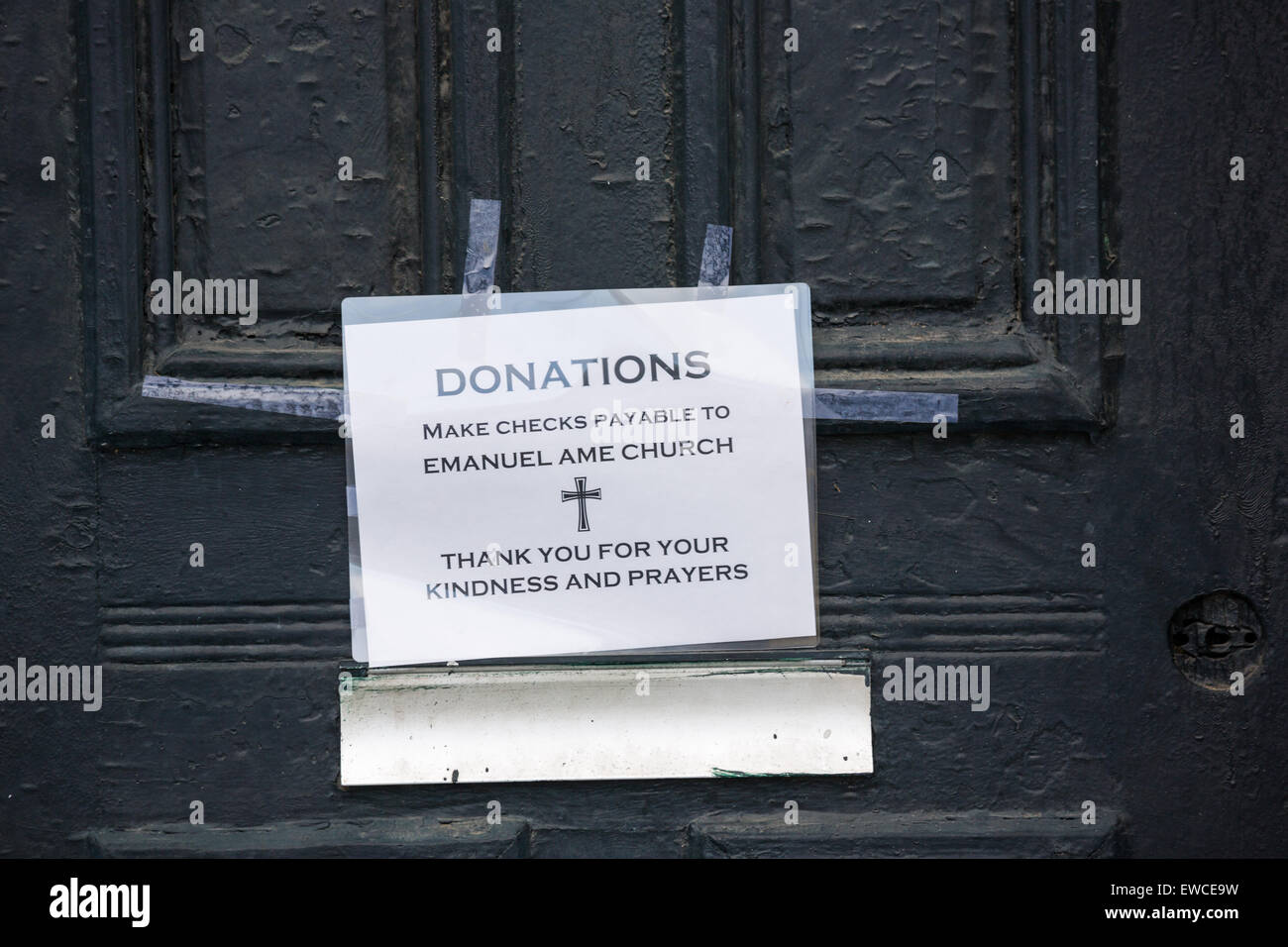 A sign telling mourners how to donate as the city continues to mourn as flowers and signs decorate a makeshift memorial outside the historic Mother Emanuel African Methodist Episcopal Church June 22, 2015 in Charleston, South Carolina. Nine people killed at the church by white supremacist, Dylann Storm Roof last Wednesday. Stock Photo