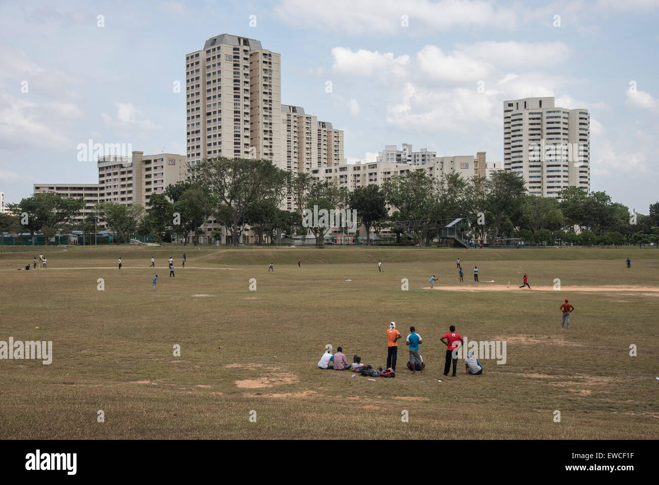 Migrant construction workers playing cricket on their day off in Singapore Stock Photo