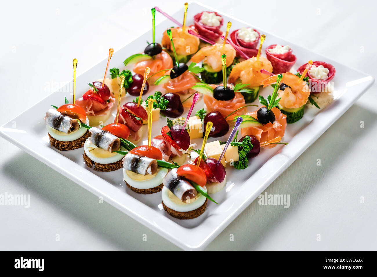 Plate with various seafood and meat canapes Stock Photo
