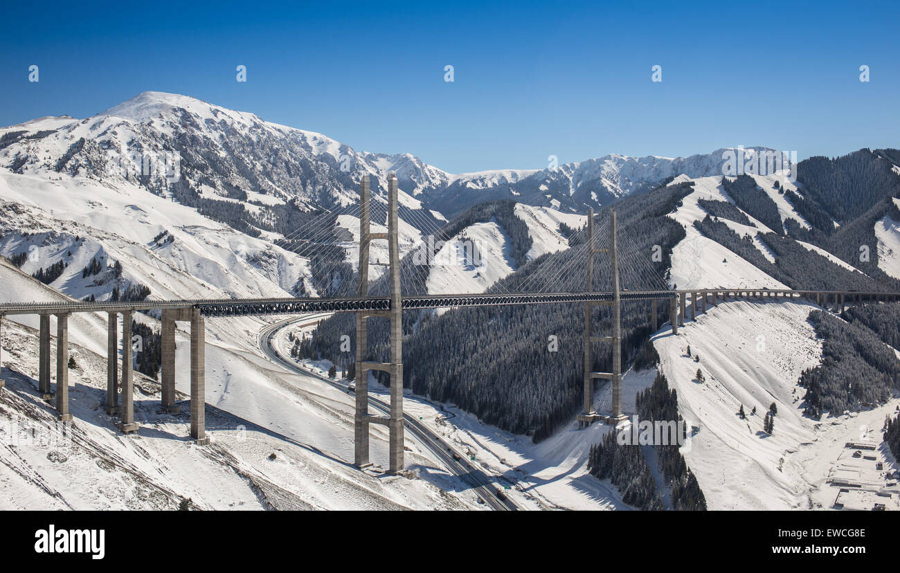Huge and beautiful road bridge in snowy mountains Stock Photo