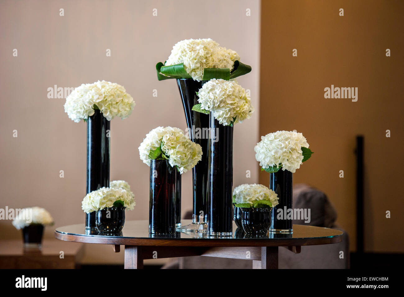 Flowers in tall vases on table hi res stock photography and images