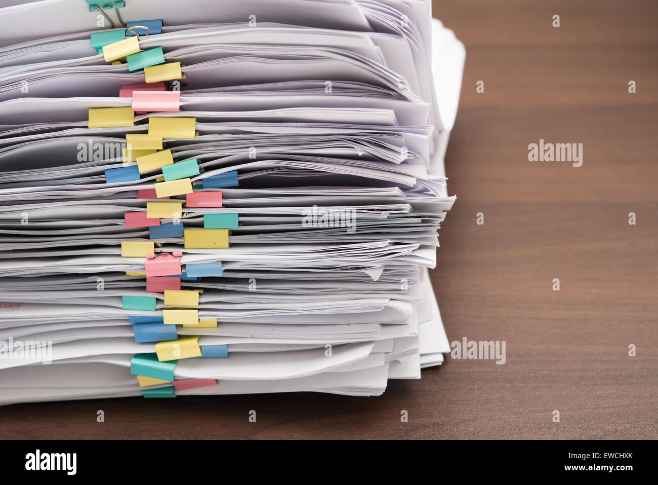 Pile of documents with colorful clips on desk stack up Stock Photo