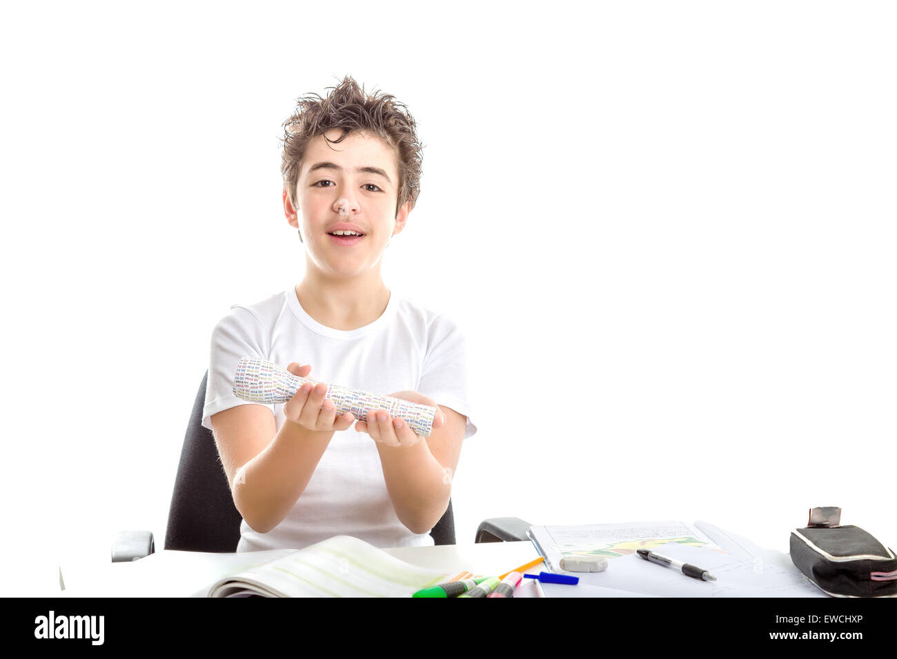 Caucasian smooth-skinned boy smiles holding 3D print labelled flashlight with both hands while doing  homework Stock Photo