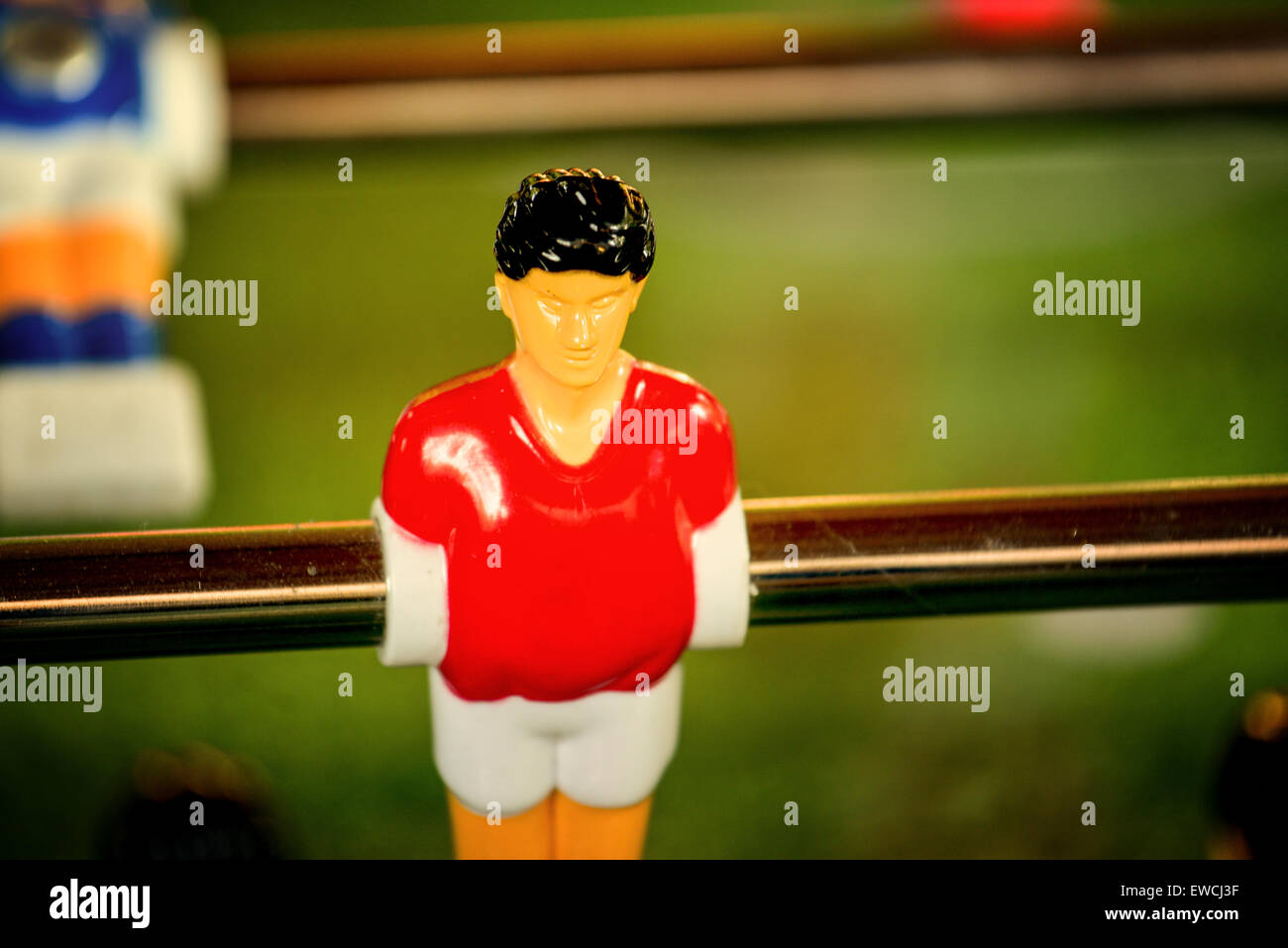 Single Player in Red Jersey, Vintage Foosball, Table Soccer or Football Kicker Game, Selective Focus, Retro Tone Effect Stock Photo