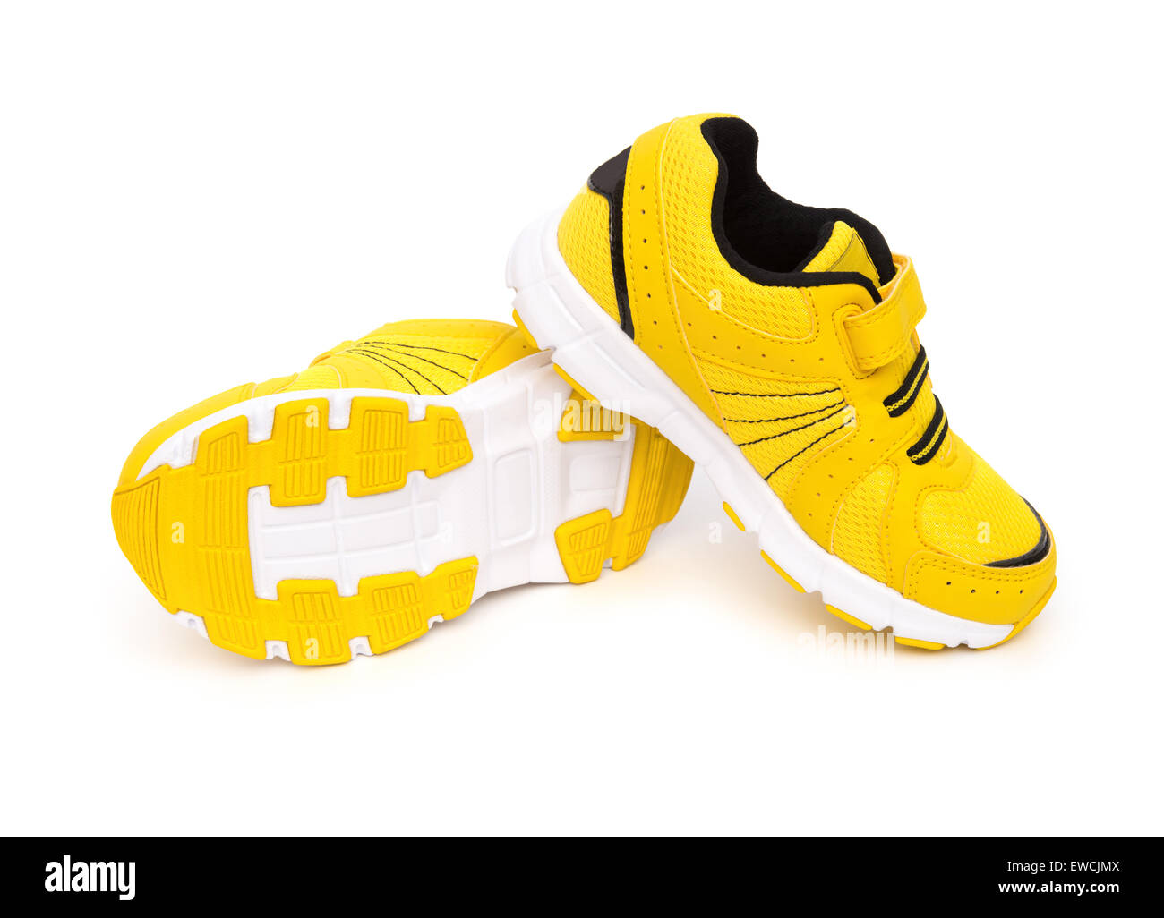 pair of yellow sporty shoes for kid on a white background Stock Photo