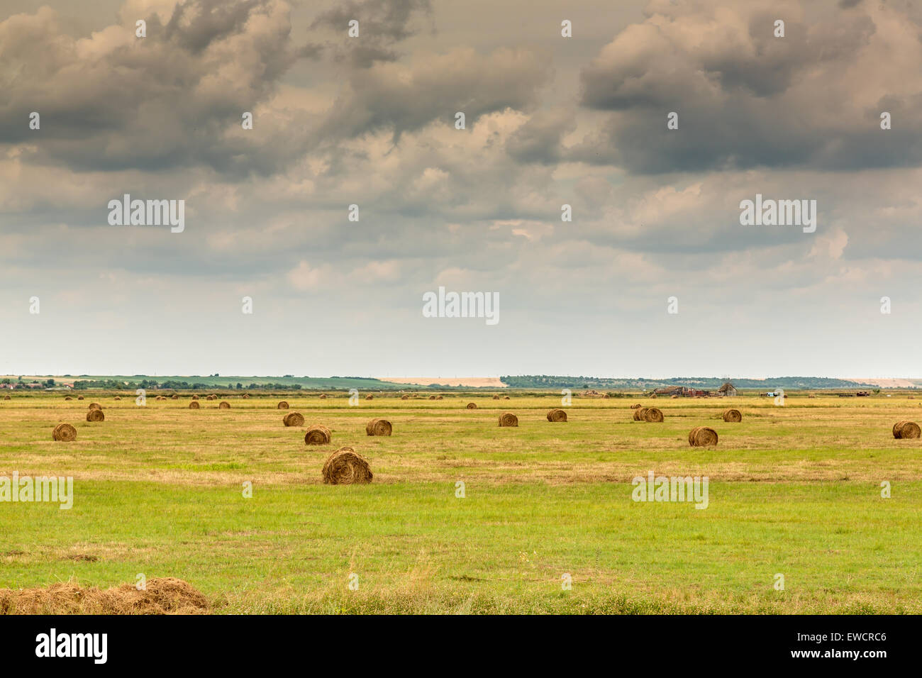 Landscape with bale of straw blue sky and clouds Stock Photo - Alamy