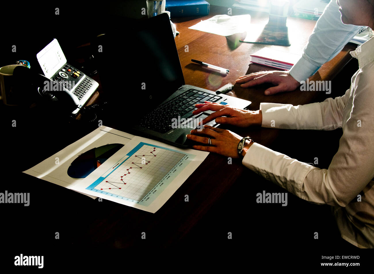 man and woman executives working on laptop. Stock Photo