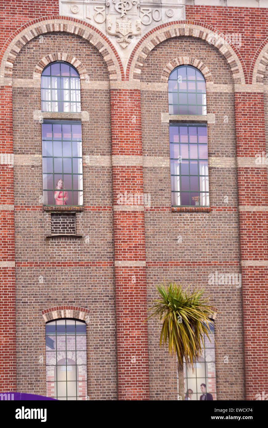 Artistic windows in Eldridge Pope brick building at Brewery Square, Dorchester South, Dorset in June Stock Photo