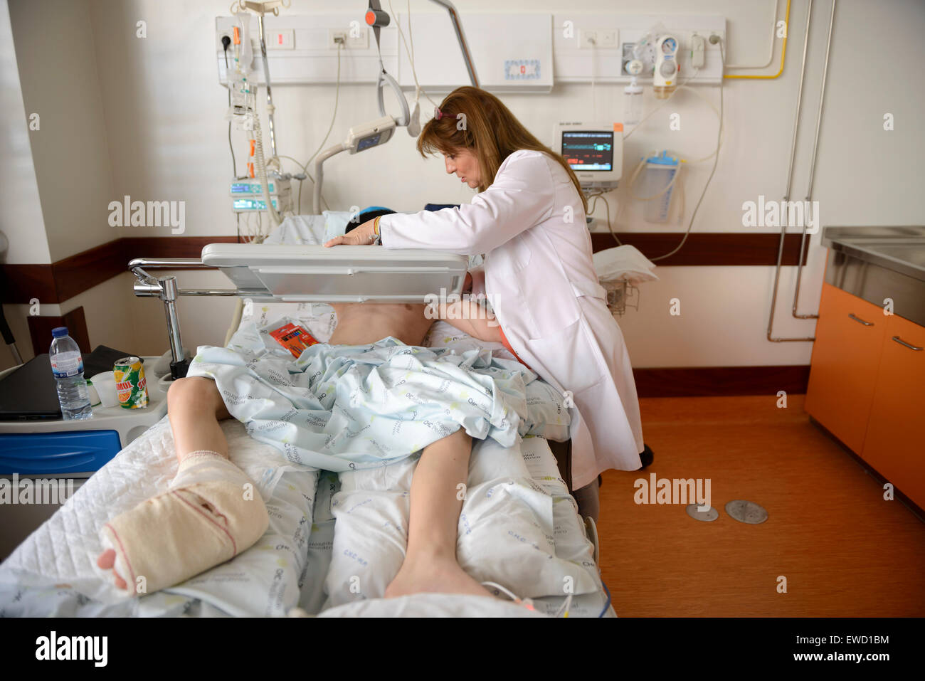 Doctor next to young patient's bed in pediatric hospital ward Stock Photo