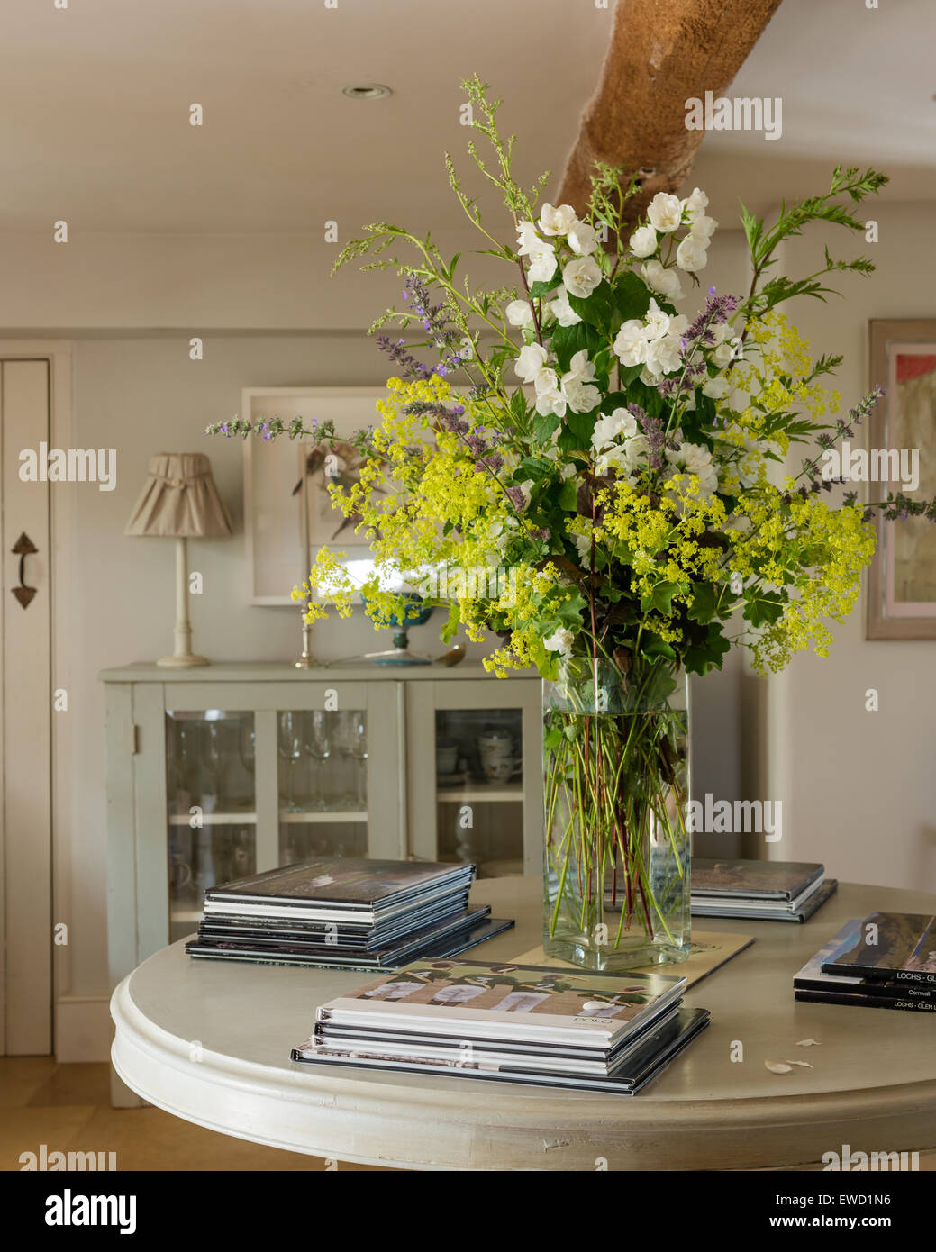 Vase of flowers on round console table Stock Photo