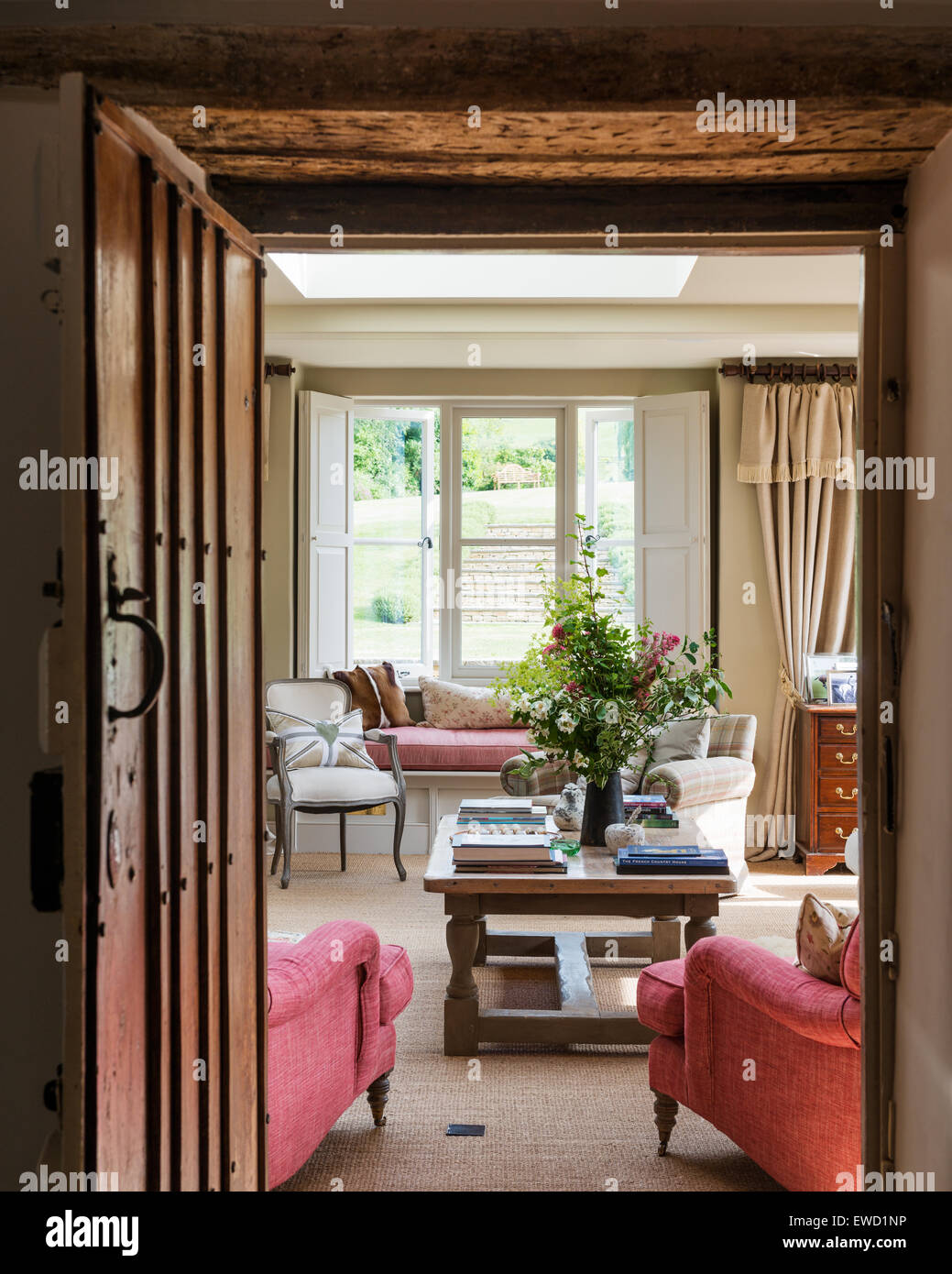 View through wooden doorway to sitting room with low coffee table and