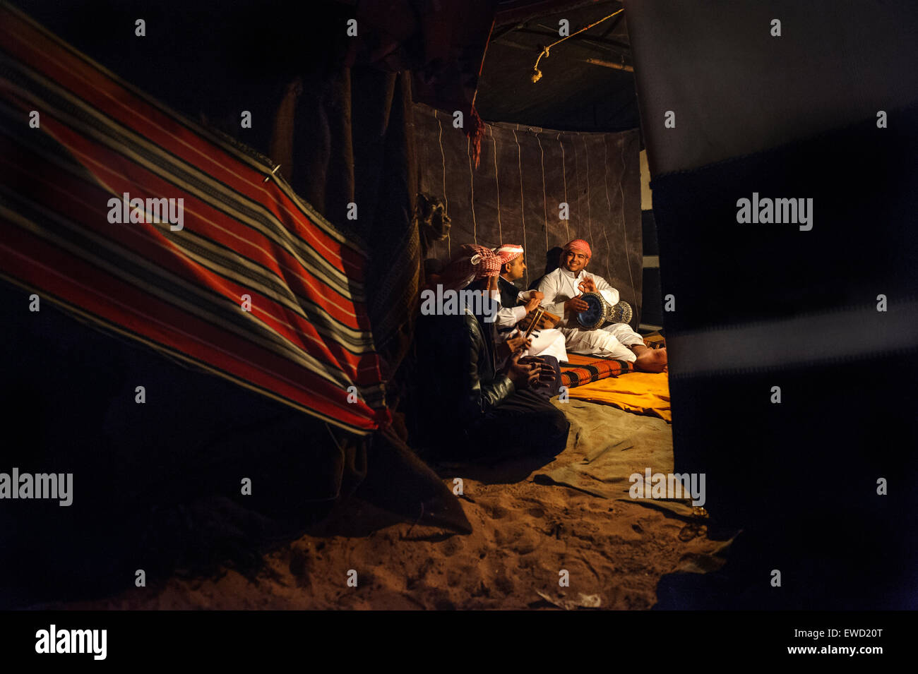 Local musicians playing in a Bedouin tent at night. Wadi Rum desert. Jordansights Stock Photo