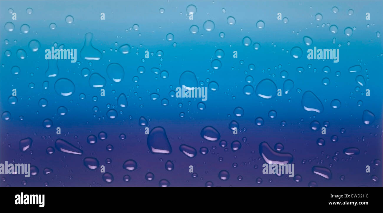 Close view of water drops against a blue background Stock Photo - Alamy
