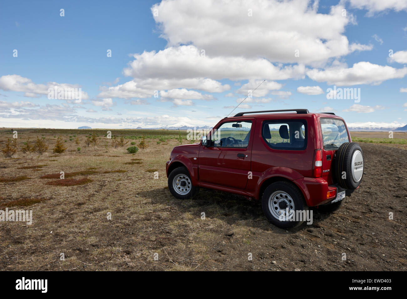 small suzuki jimny hire car jeep driven off road into fields in iceland Stock Photo