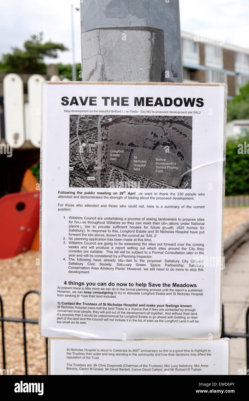 Fliers attached to metal post in public park advertising a campaign to save local meadow land from being developed Stock Photo