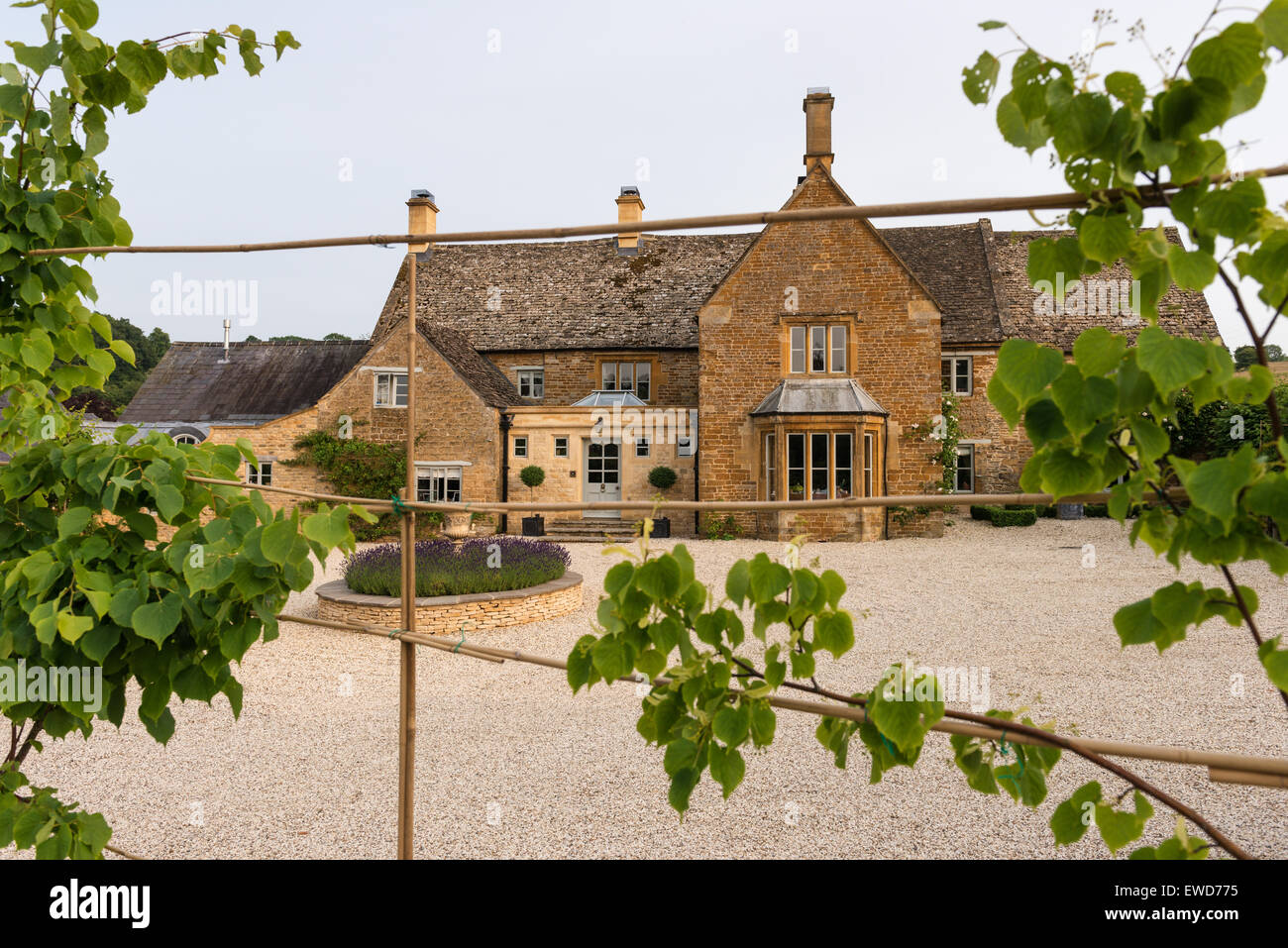 Exterior facade of 17th century Cotswold cottage with extentions Stock Photo