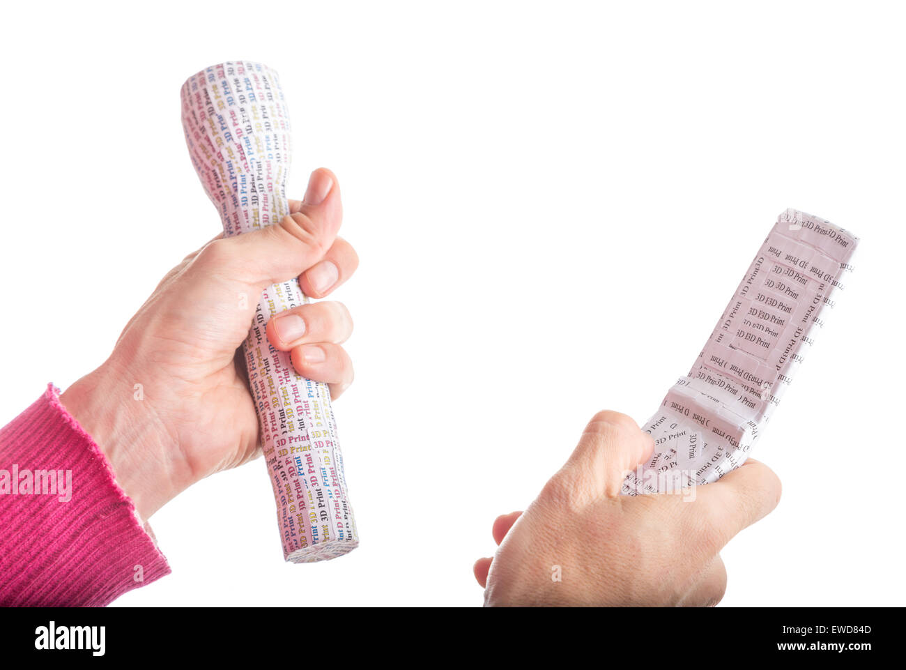 Adult hands in red sweater holding 3D Print labelled prototypes of white flashlight and clam shell mobile phone Stock Photo