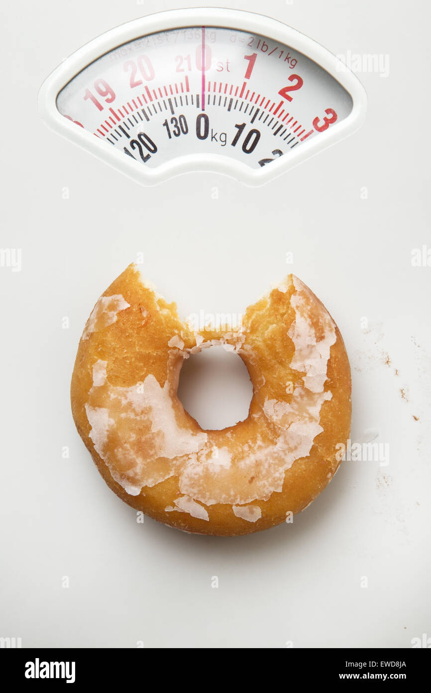 single donut shot on a scale for weighing yourself Stock Photo