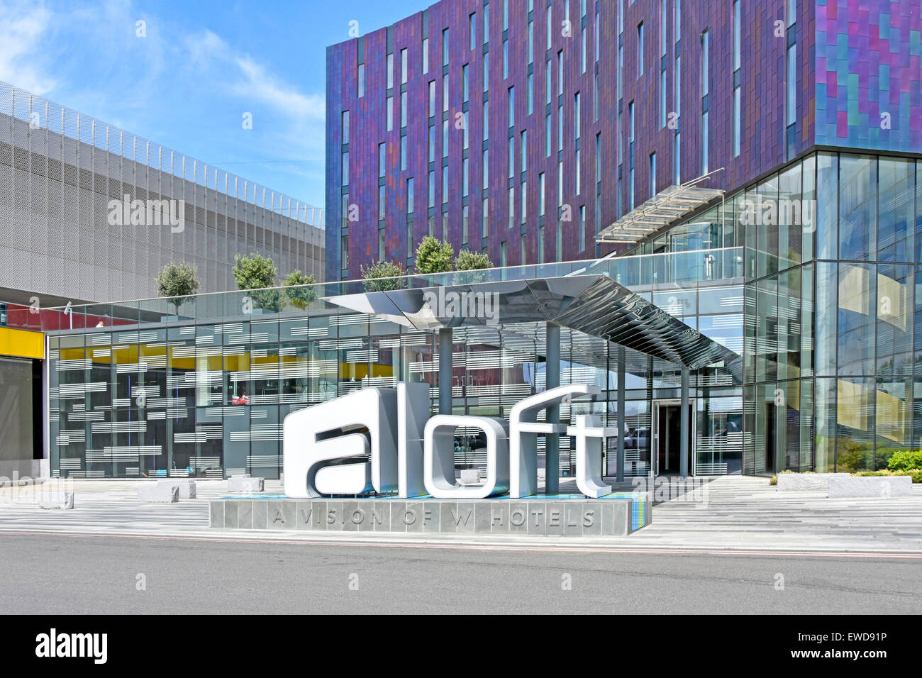 Hotel modern architecture colourful cladding panels on façade of aloft W hotel building adjacent to London Docklands Excel complex London England UK Stock Photo