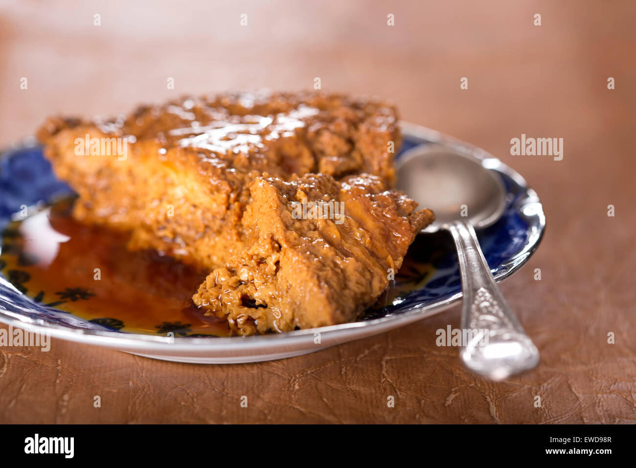 French creme caramel dessert or flan on a blue plate Stock Photo