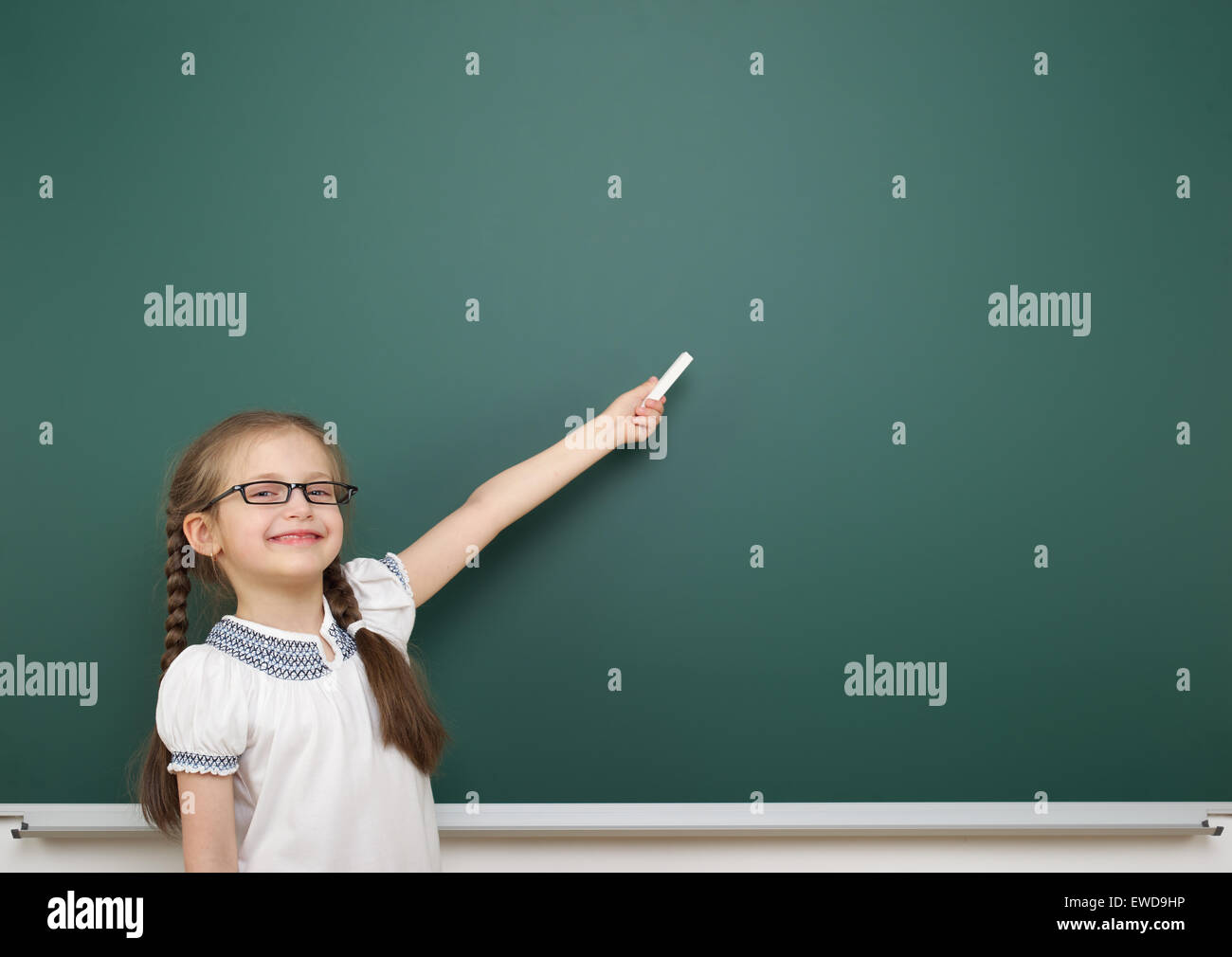 Schoolgirl near school board Stock Photo - Alamy