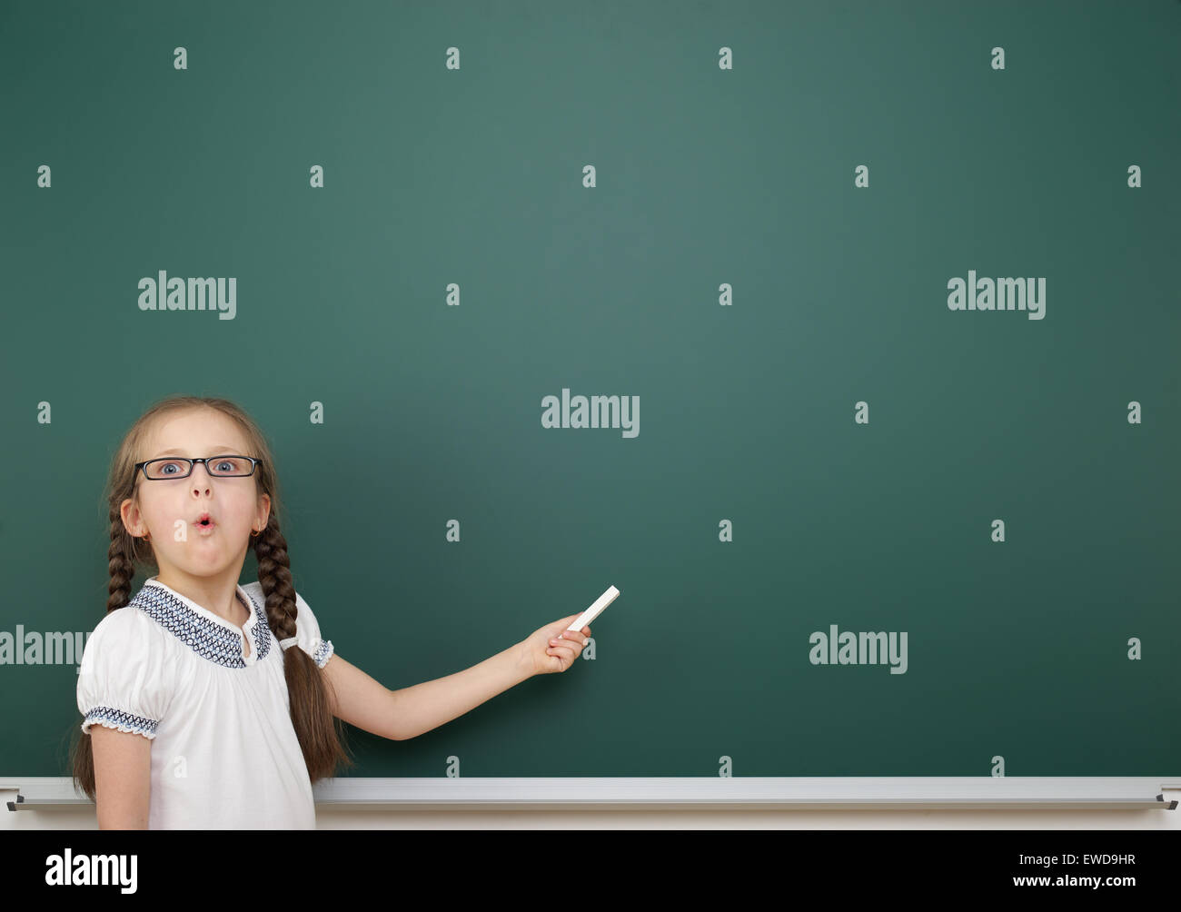 Schoolgirl near school board Stock Photo - Alamy
