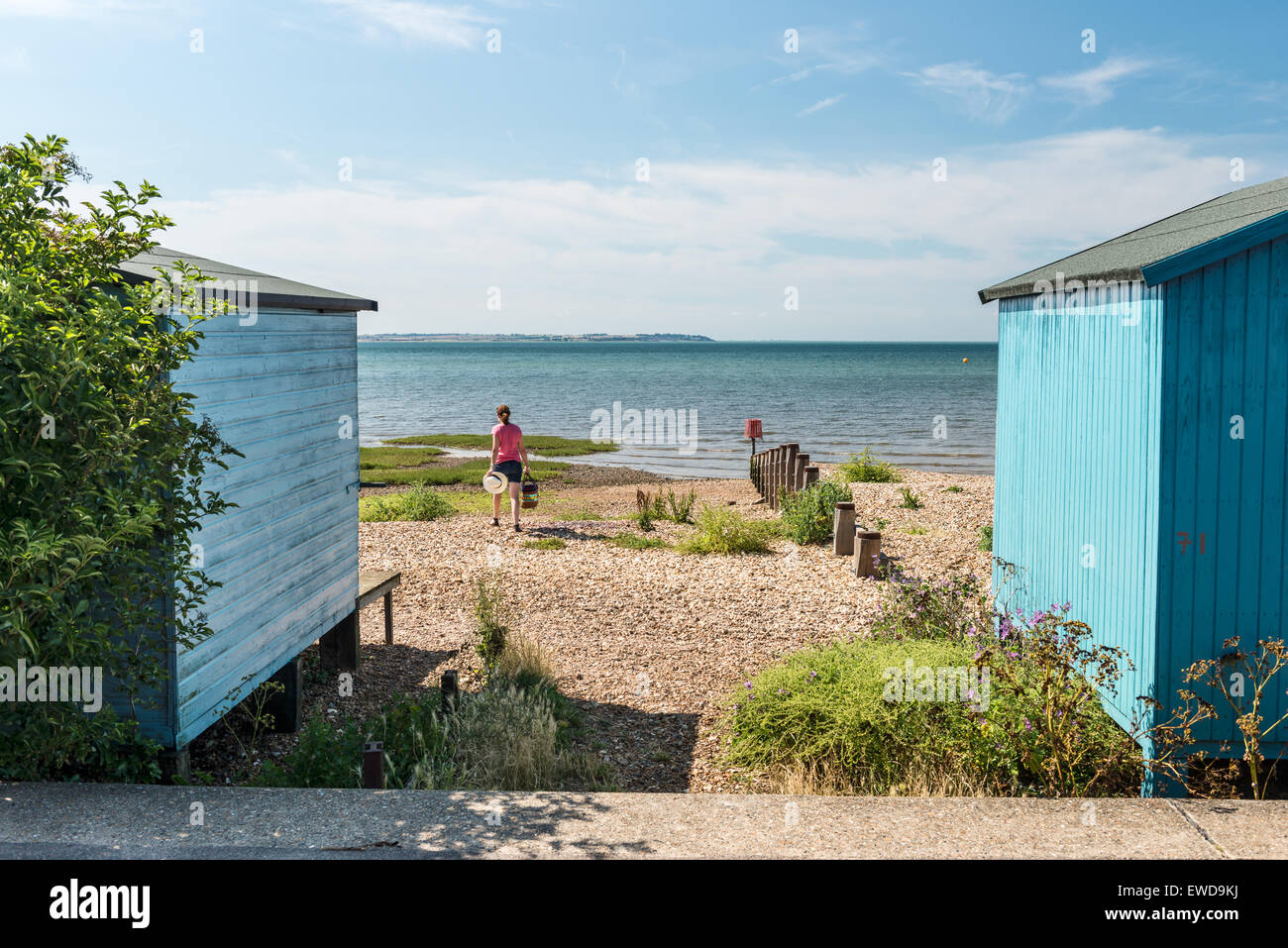 External facade of beach huts with sea view on Whitstable beach Stock Photo