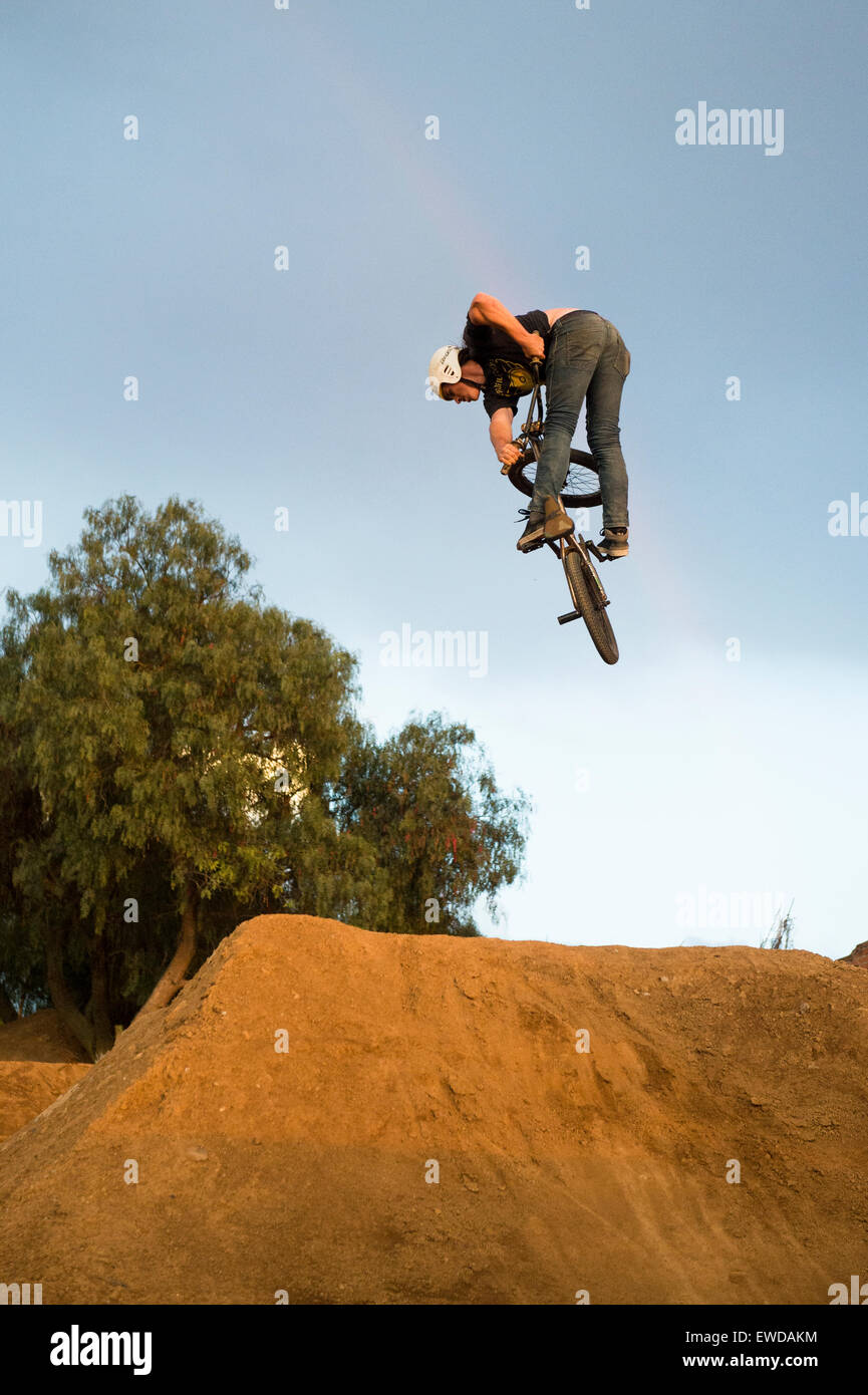 BMX rider jumping over dirt ramp Stock Photo Alamy