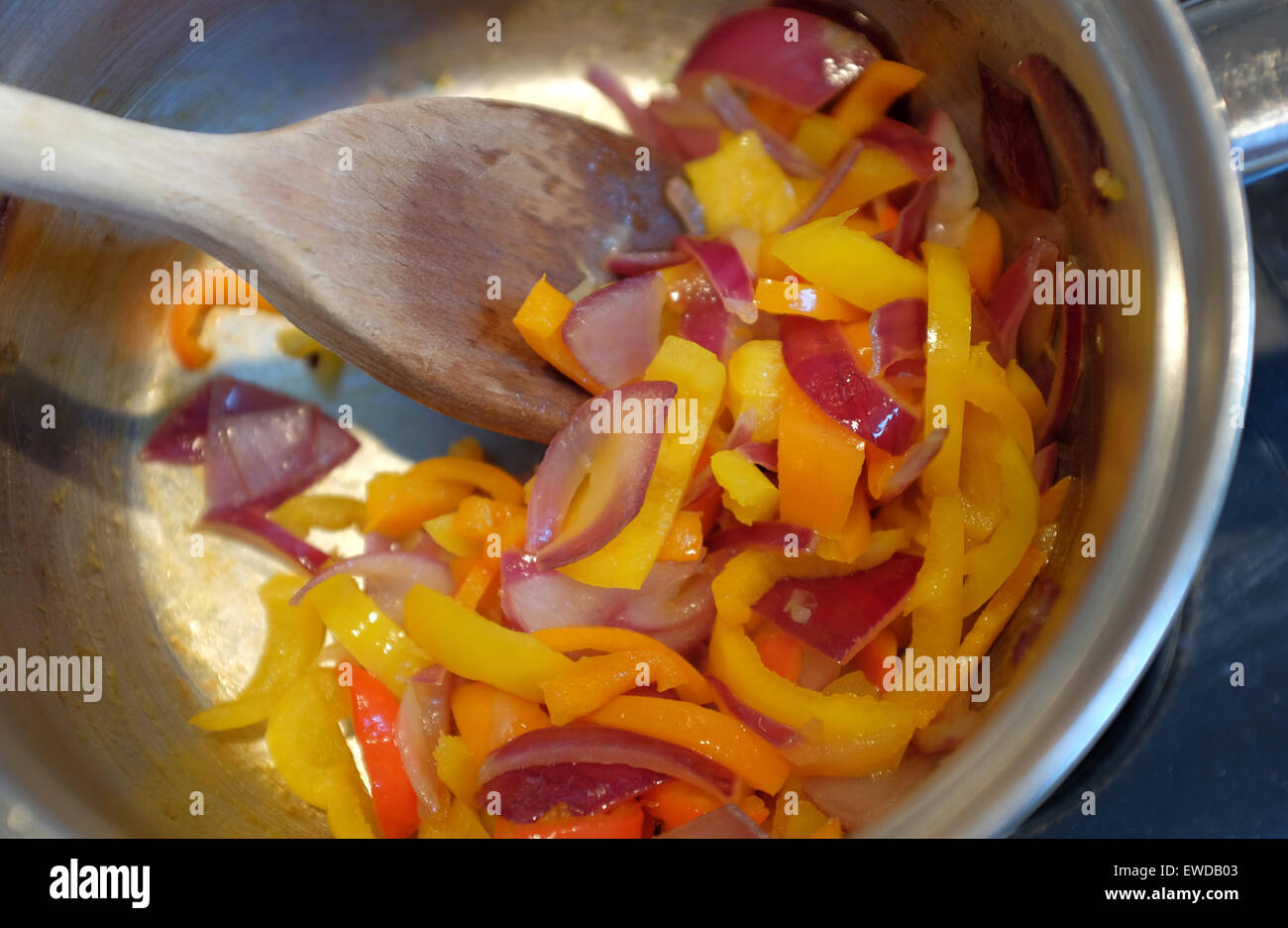 Chopped peppers and onions frying in a pan Stock Photo