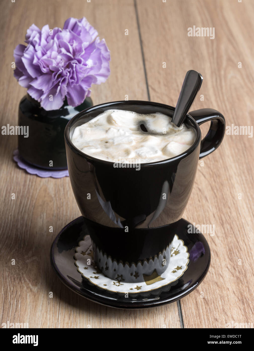 Coffee with marshmallows in a black mug on the wooden table Stock Photo
