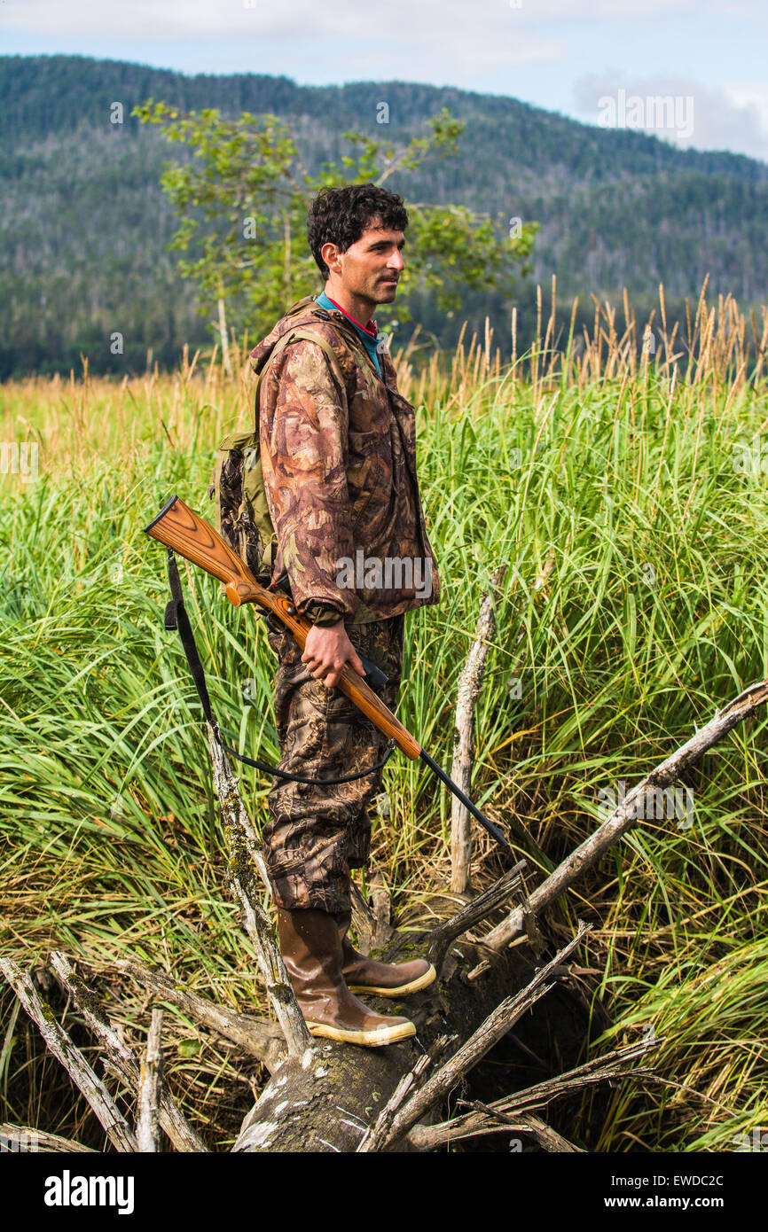 Hunter with rifle, Alexander Archipelago, Southeast Alaska, USA Stock Photo