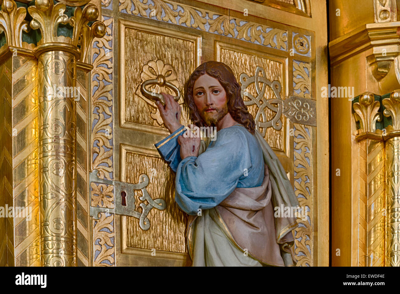 Wood Carved Statue Of Jesus Christ Standing At A Golden Door And