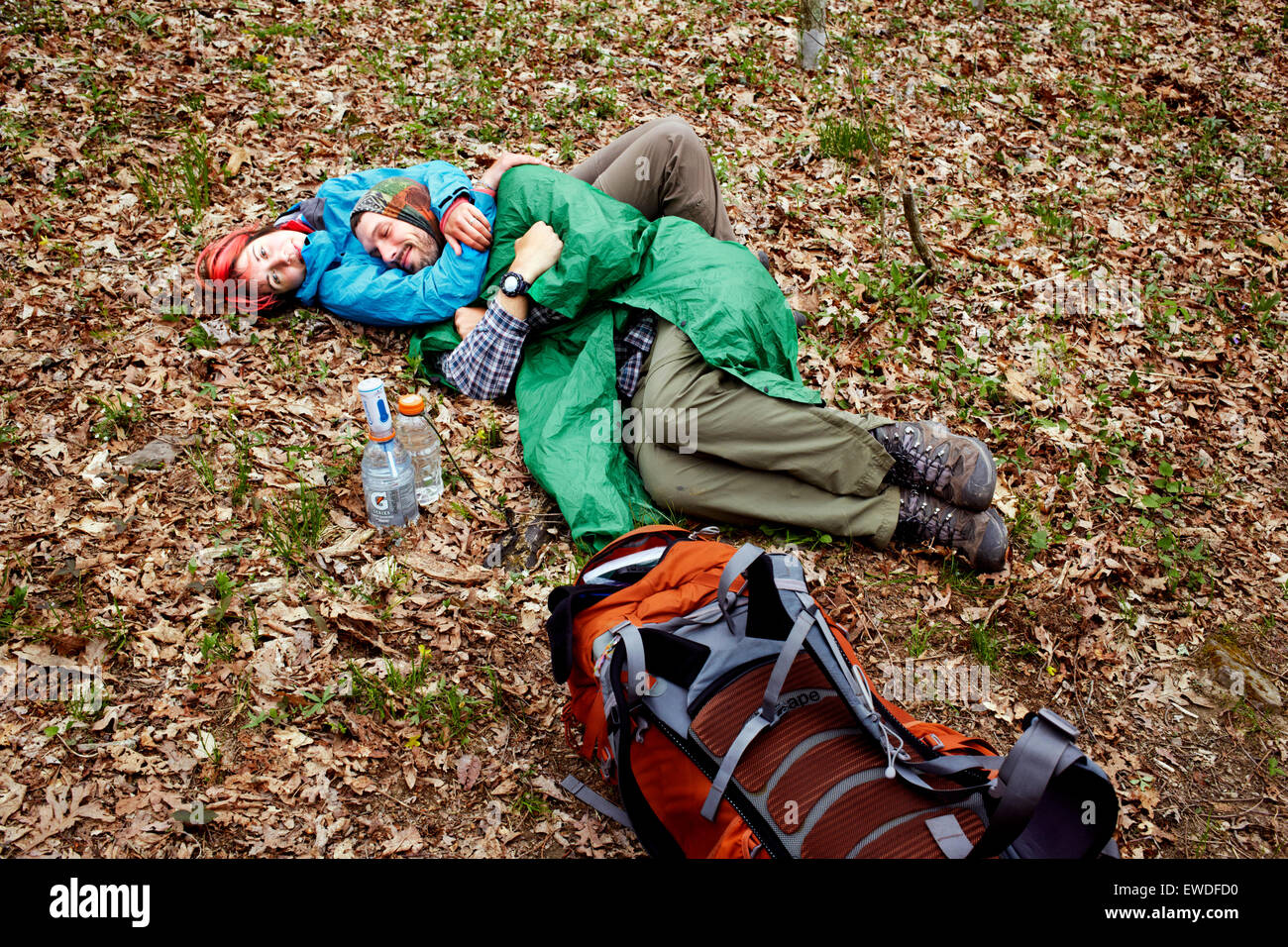 Two hikers cuddle on a misty day. Stock Photo