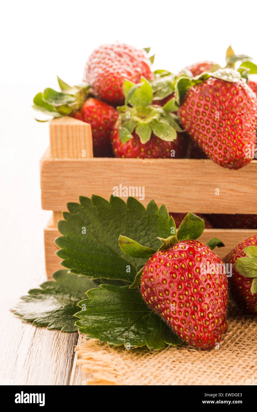 Strawberries over odl brown wooden table background Stock Photo - Alamy