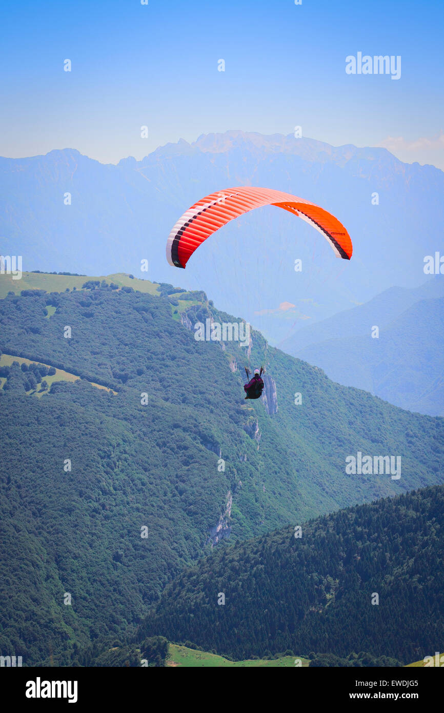 Paragliding over the Italian lake, Garda, above Malcesine with the ghosted hills in the background Stock Photo
