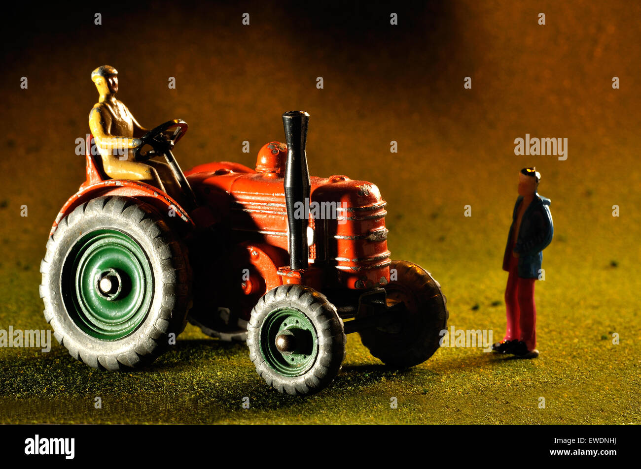 Vintage model Field marshall tractor with miniature figure in studio setting Stock Photo