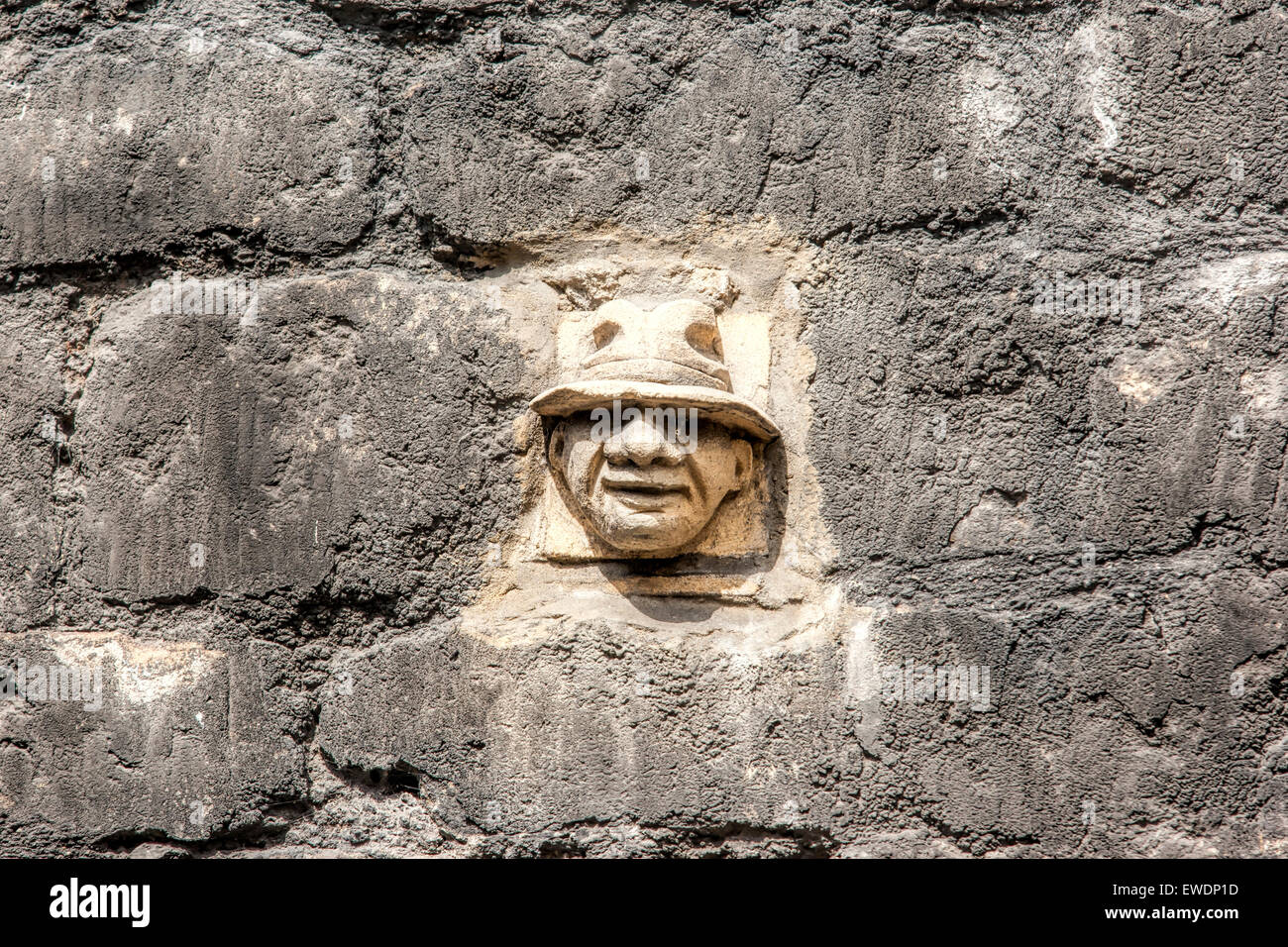Stone face carved in Bath Stone in the wall at Walcot Street in Bath one of more than 30 grotesques. Stock Photo